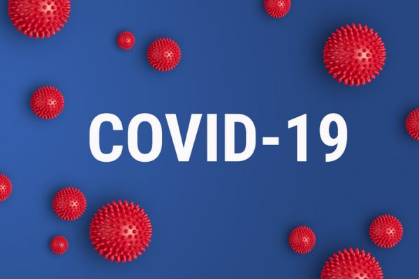 Inscription COVID-19 on blue background with red strain model of coronavirus Inscription COVID-19 on blue background. World Health Organization WHO introduced new official name for Coronavirus disease named COVID-19